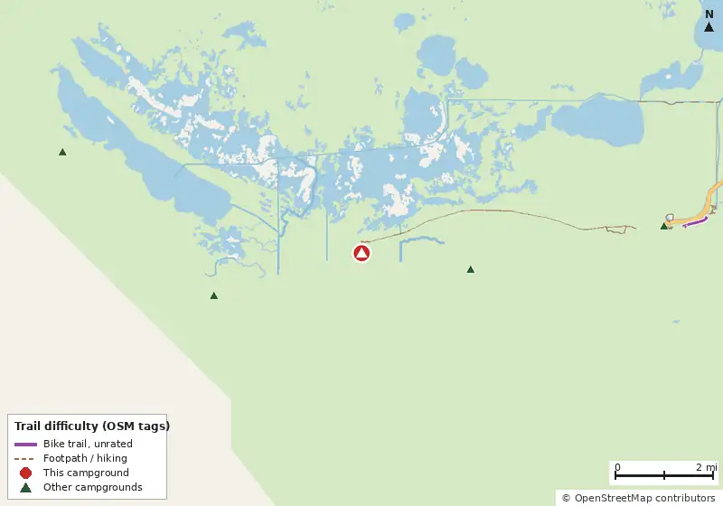 Map of roads, water and trails within about 5 miles of Clubhouse Beach Campsite, with bike trails colored by their OpenStreetMap difficulty tags