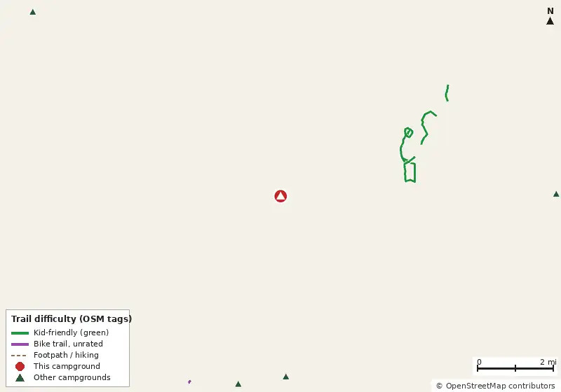 Map of roads, water and trails within about 5 miles of The Woods RV and Park Model Resort, with bike trails colored by their OpenStreetMap difficulty tags
