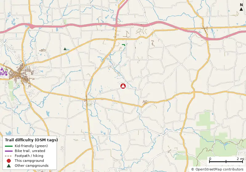 Map of roads, water and trails within about 5 miles of Yogi Bear's Jellystone Park at Kozy Rest, with bike trails colored by their OpenStreetMap difficulty tags