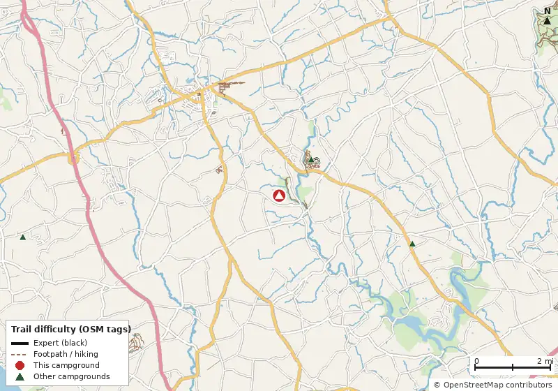 Map of roads, water and trails within about 5 miles of Yogi Bear's Jellystone Park Camp-Resort, with bike trails colored by their OpenStreetMap difficulty tags